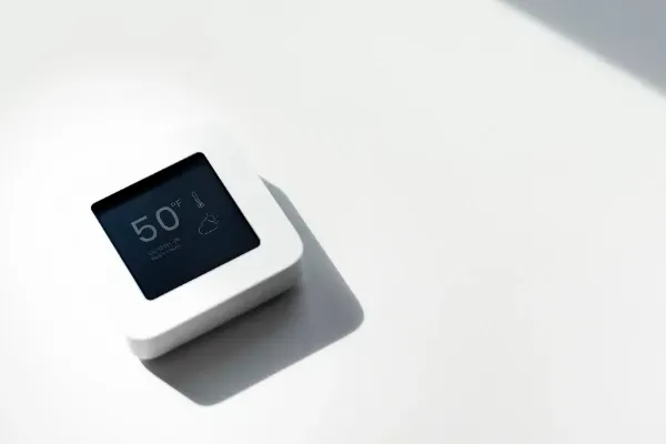 A small white device with a screen that says 50 on it