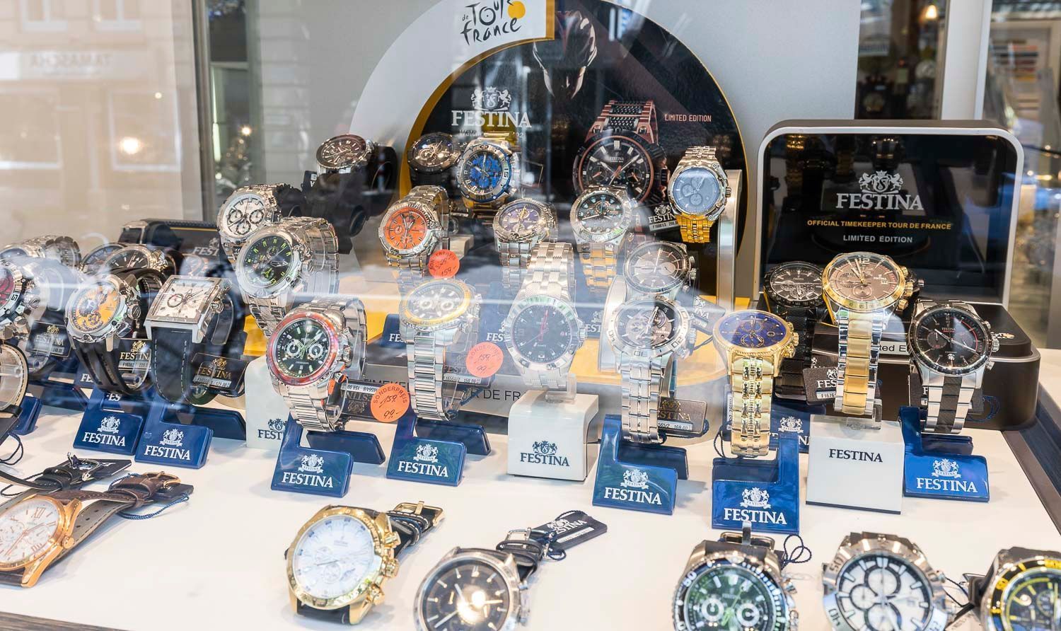 Ein Schaufenster mit verschiedenen Armbanduhren der Marke Festina; silberne, goldene und bunte Zifferblätter.