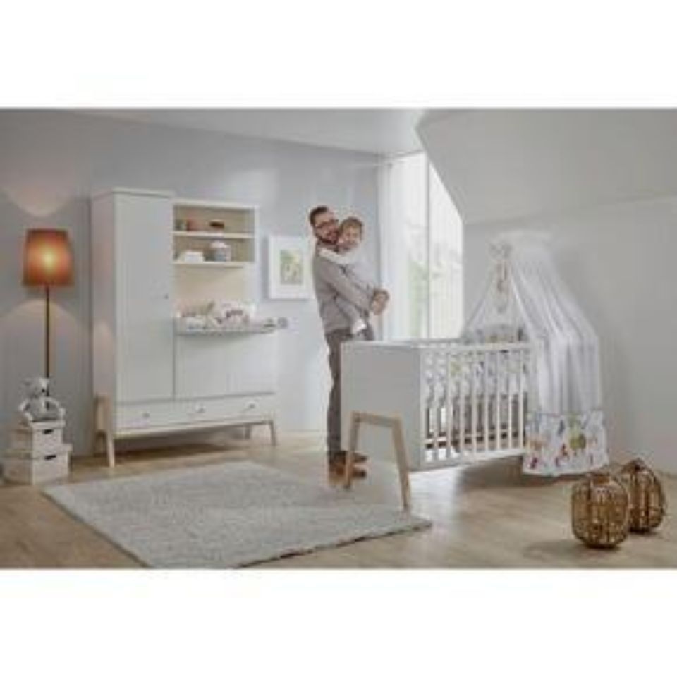 Erwachsener mit Kind am Kinderbett