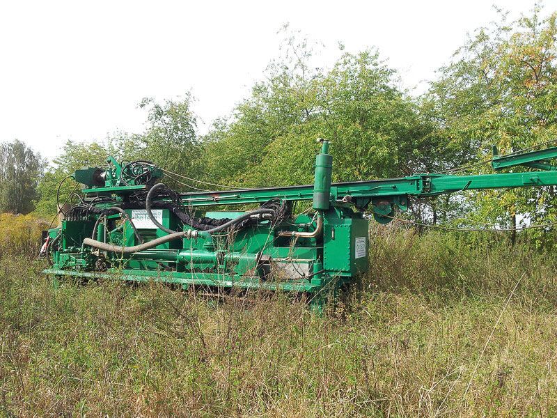 Eine grüne Maschine steht auf einem Feld mit hohem Gras - IBOTECH Bohr- und Brunnenbau GmbH aus Zöberitz bei Landsberg
