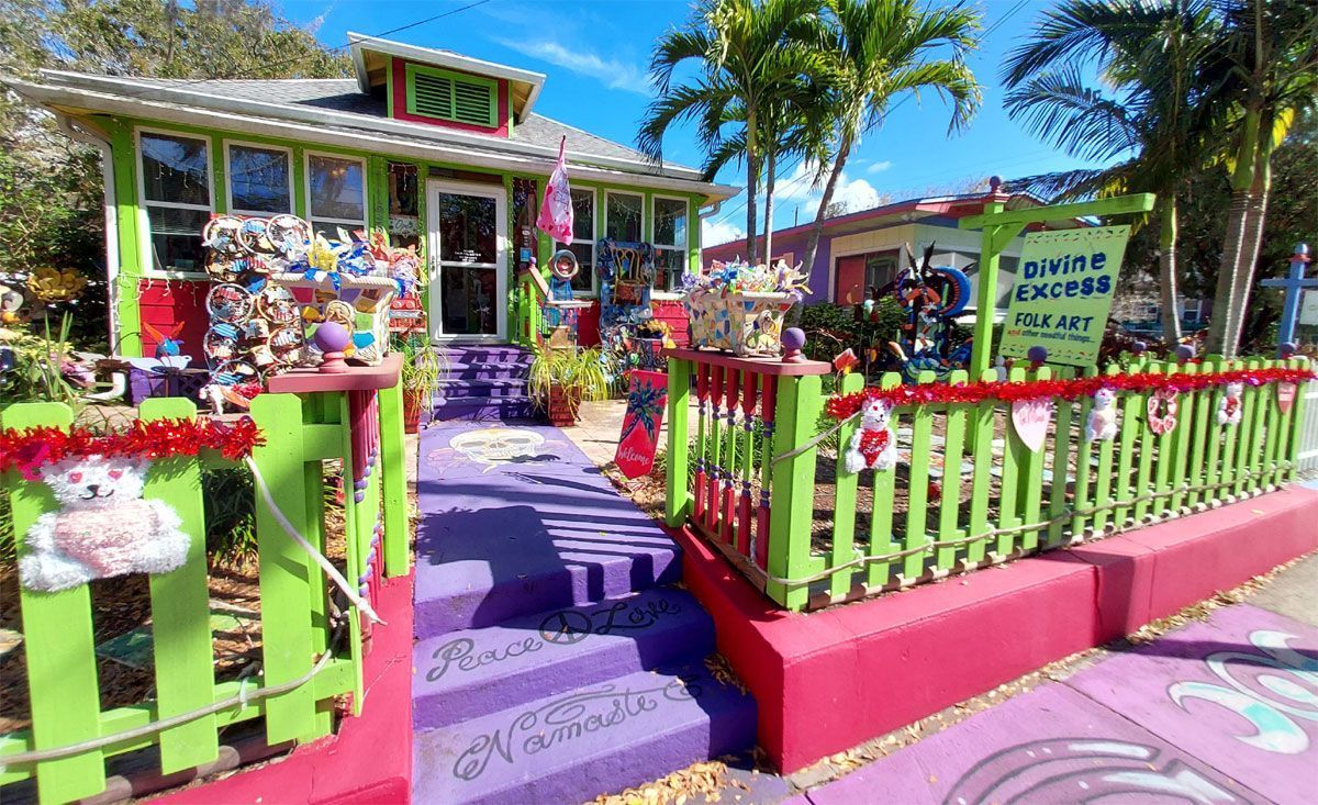 Colorful, whimsical shopfront; green, pink, and purple exterior, stuffed animals, sign