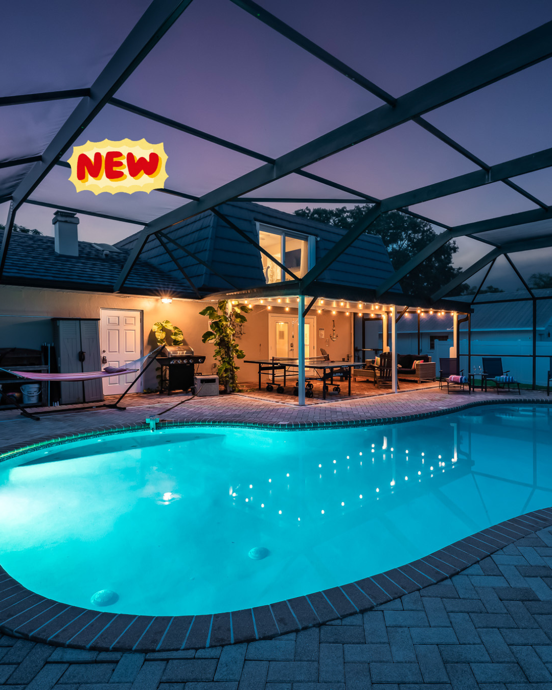 Outdoor pool with tropical mural and pink flamingo float.