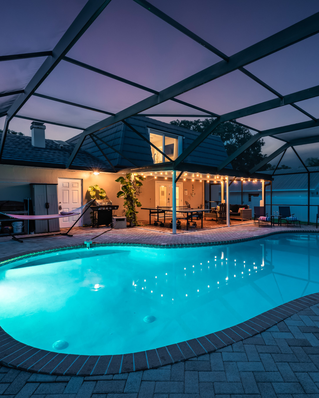 Outdoor pool with tropical mural and pink flamingo float.