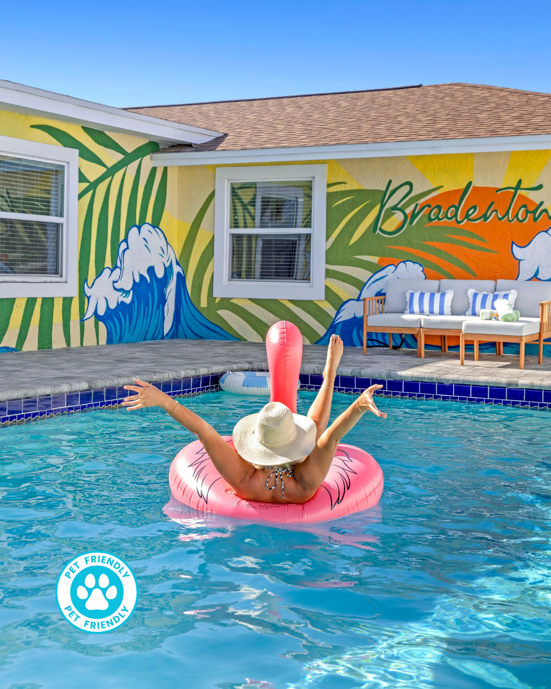 Vacation vibe: pool, flamingo float, and Bradenton wall art.