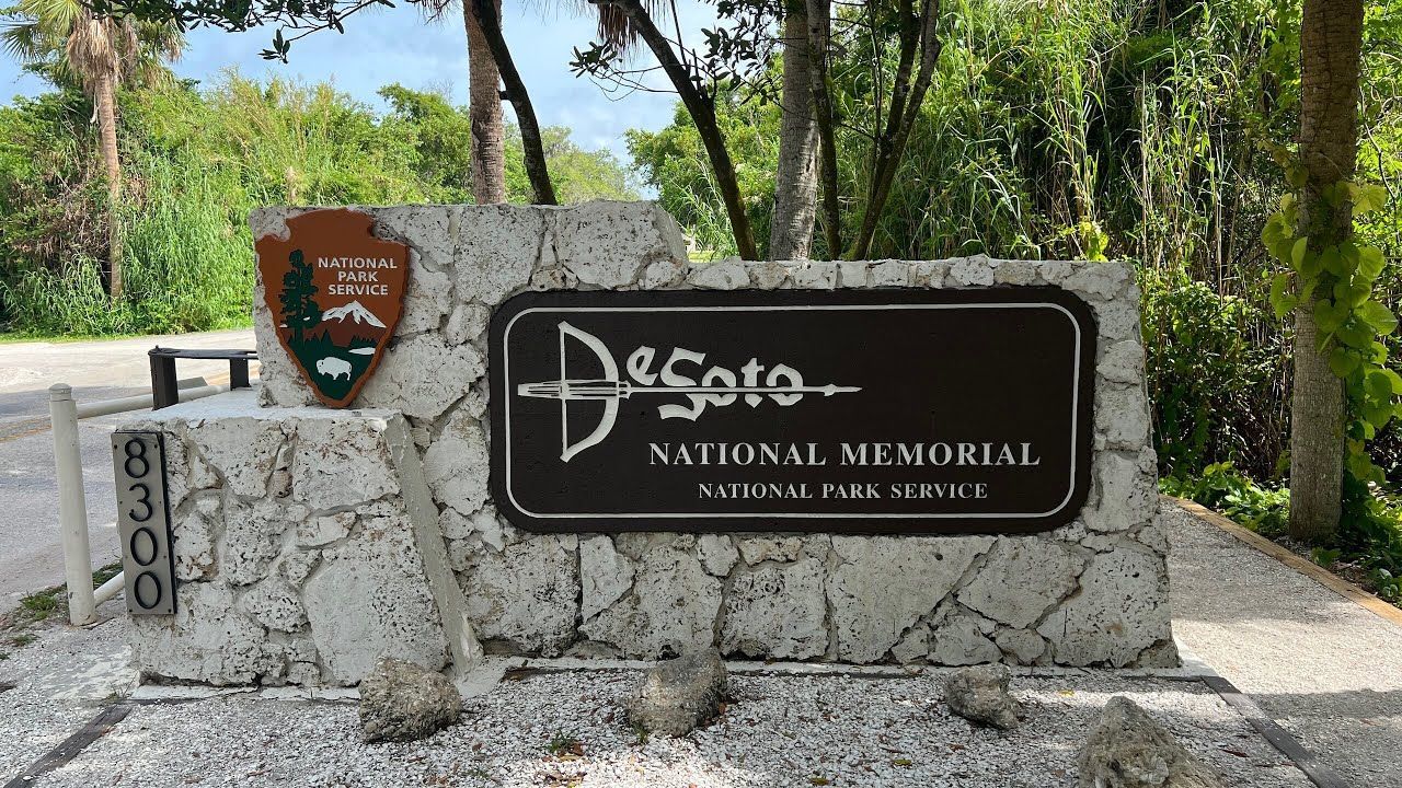 Desoto National Memorial entrance sign with brown sign and park service logo, brick structure, Florida.