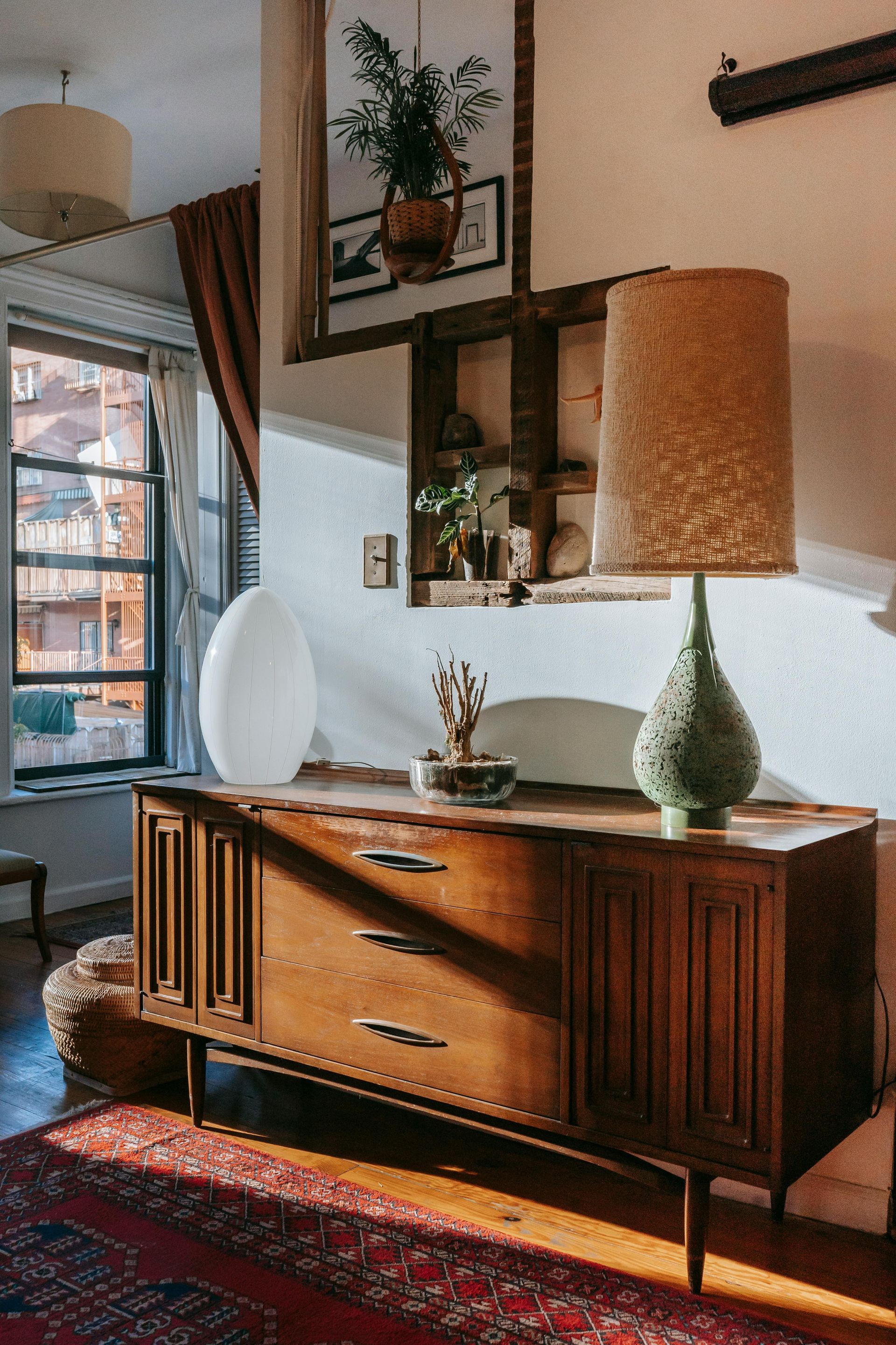 Mid-century sideboard with lamps and decor in a cozy sunlit room