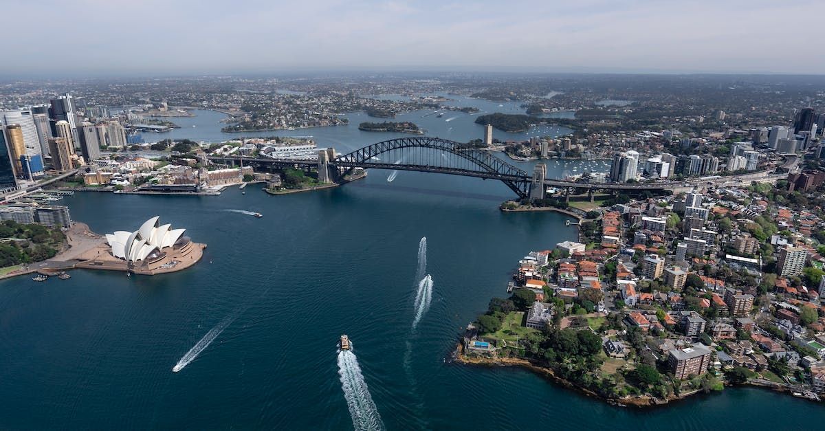 An aerial view of sydney harbor and the opera house.