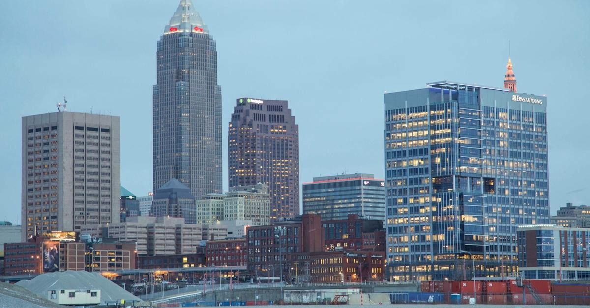 A city skyline at night with a lot of tall buildings