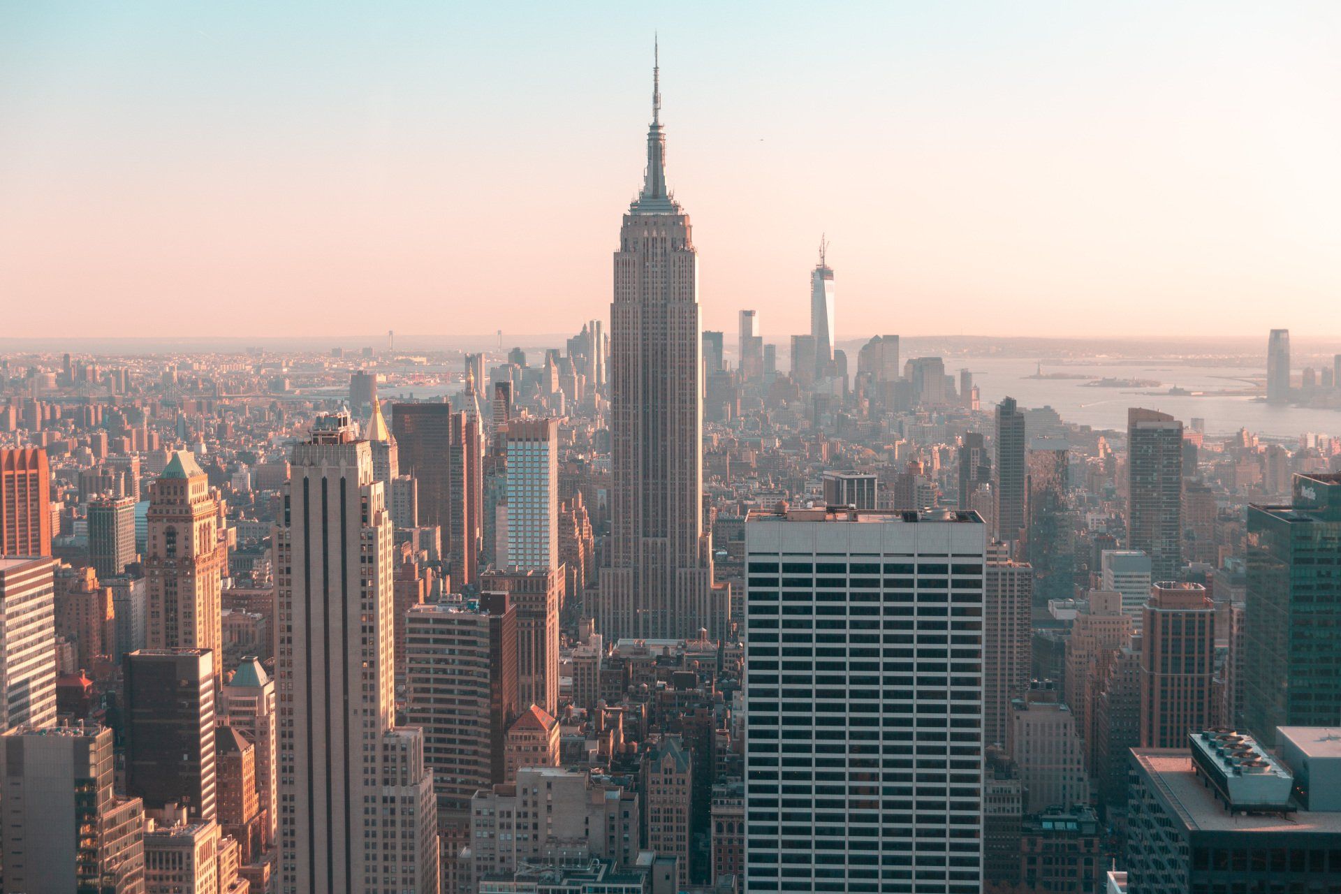 An aerial view of a city skyline with the empire state building in the foreground.