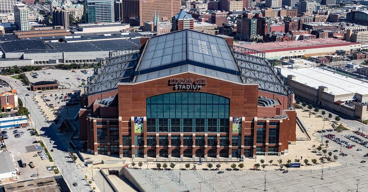 An aerial view of a large brick building in the middle of a city.