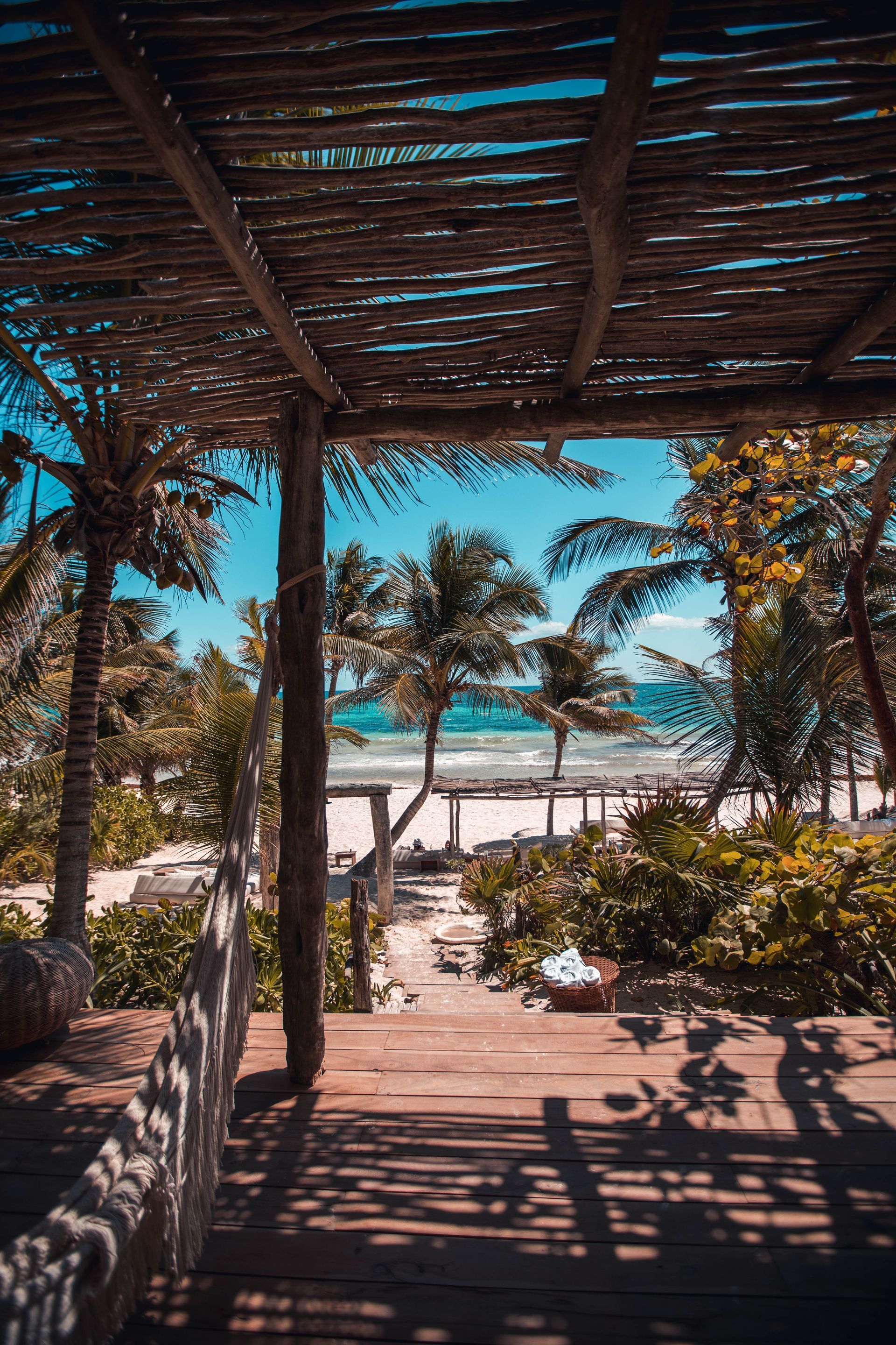 There is a wooden walkway leading to the beach.