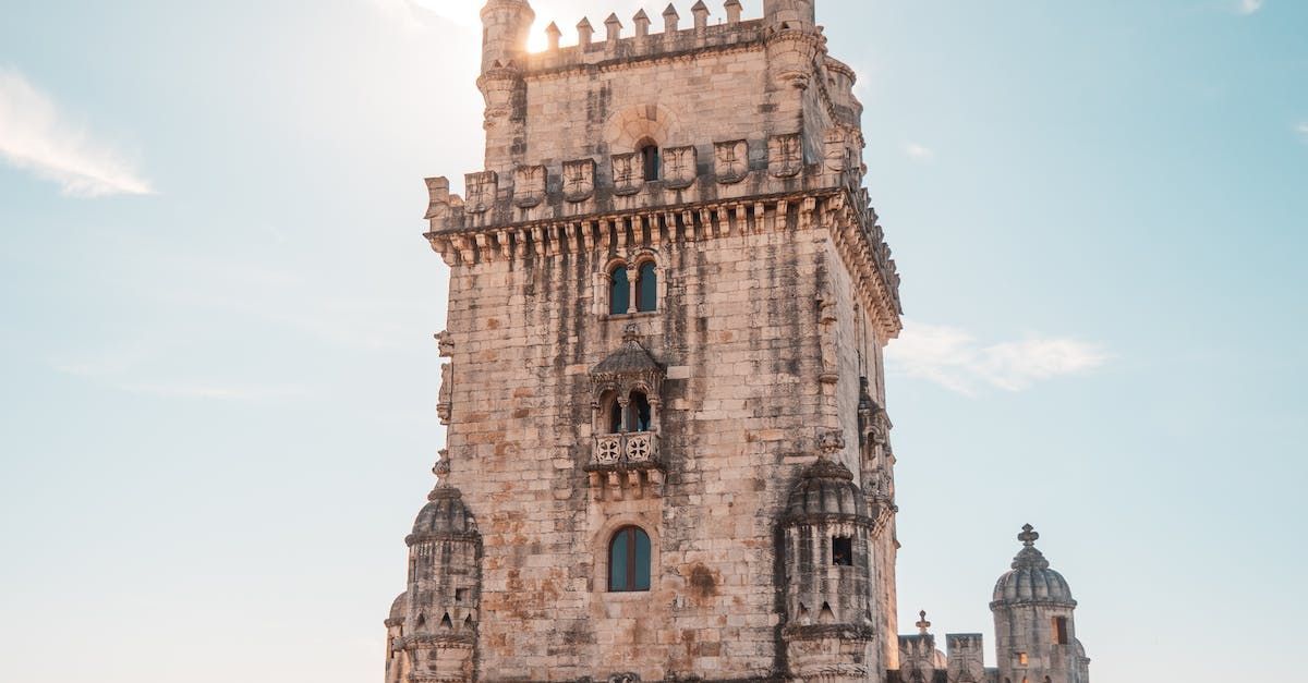 A large stone tower with a blue sky in the background.