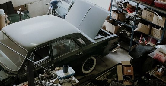 A car in a garage with the hood open