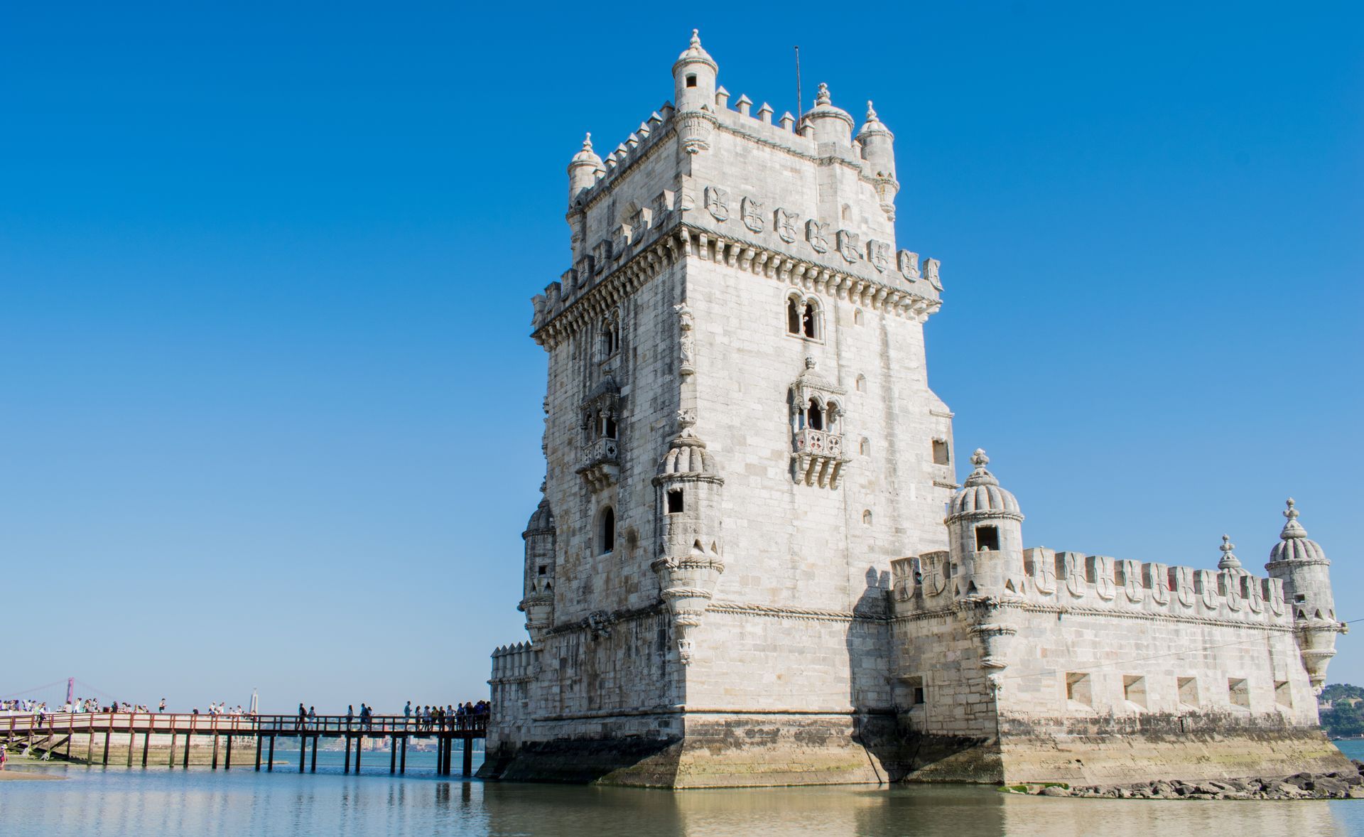 Alojamento Local Portugal Unveiled: Navigating AL - a large white castle is sitting on top of a small island in the middle of a body of water .