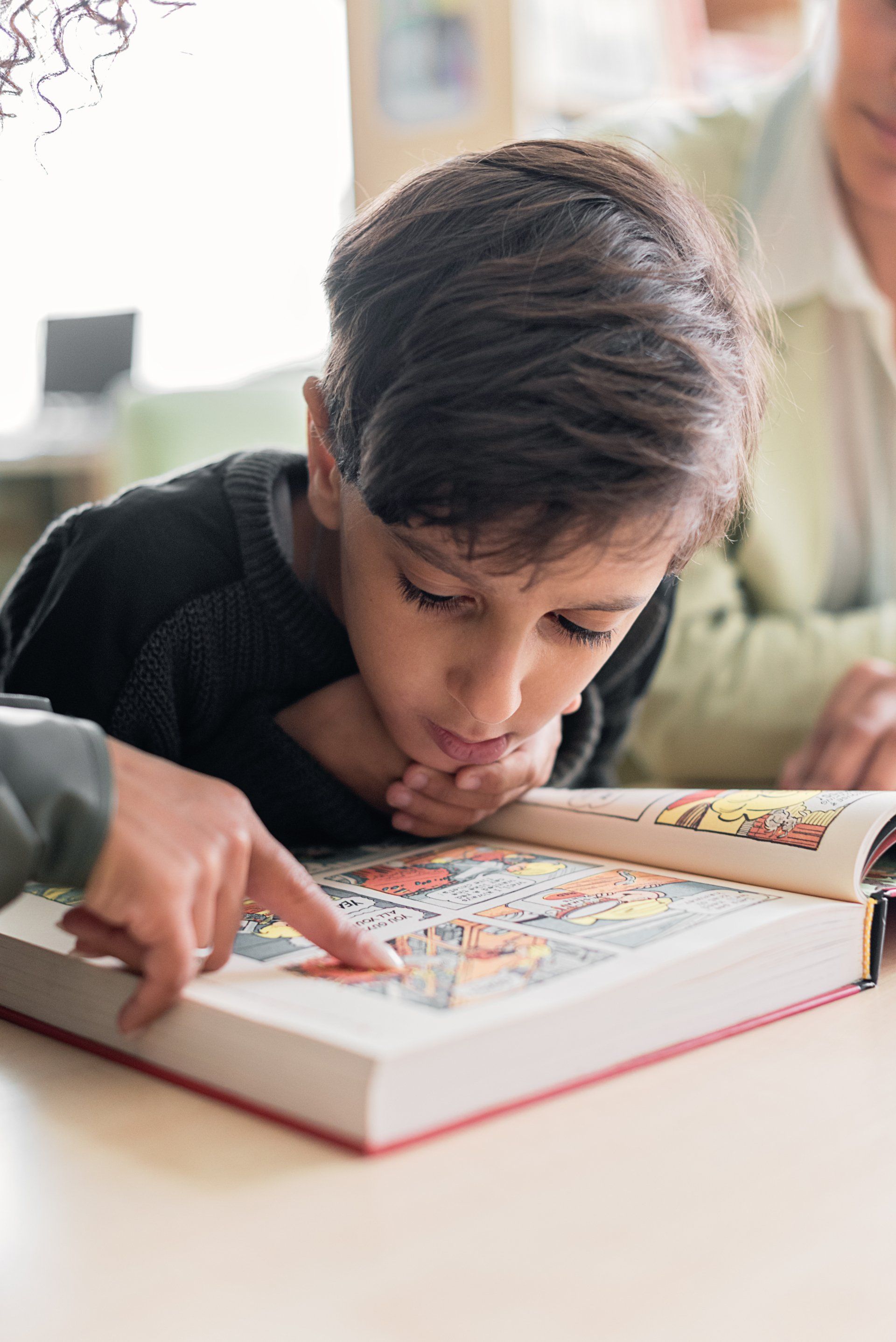 Enfant qui lit une bande dessinée