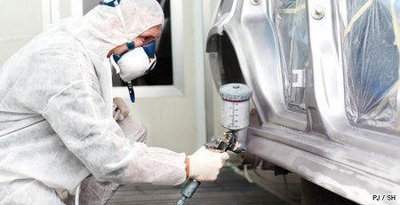 Carrossier avec un pistolet à peinture