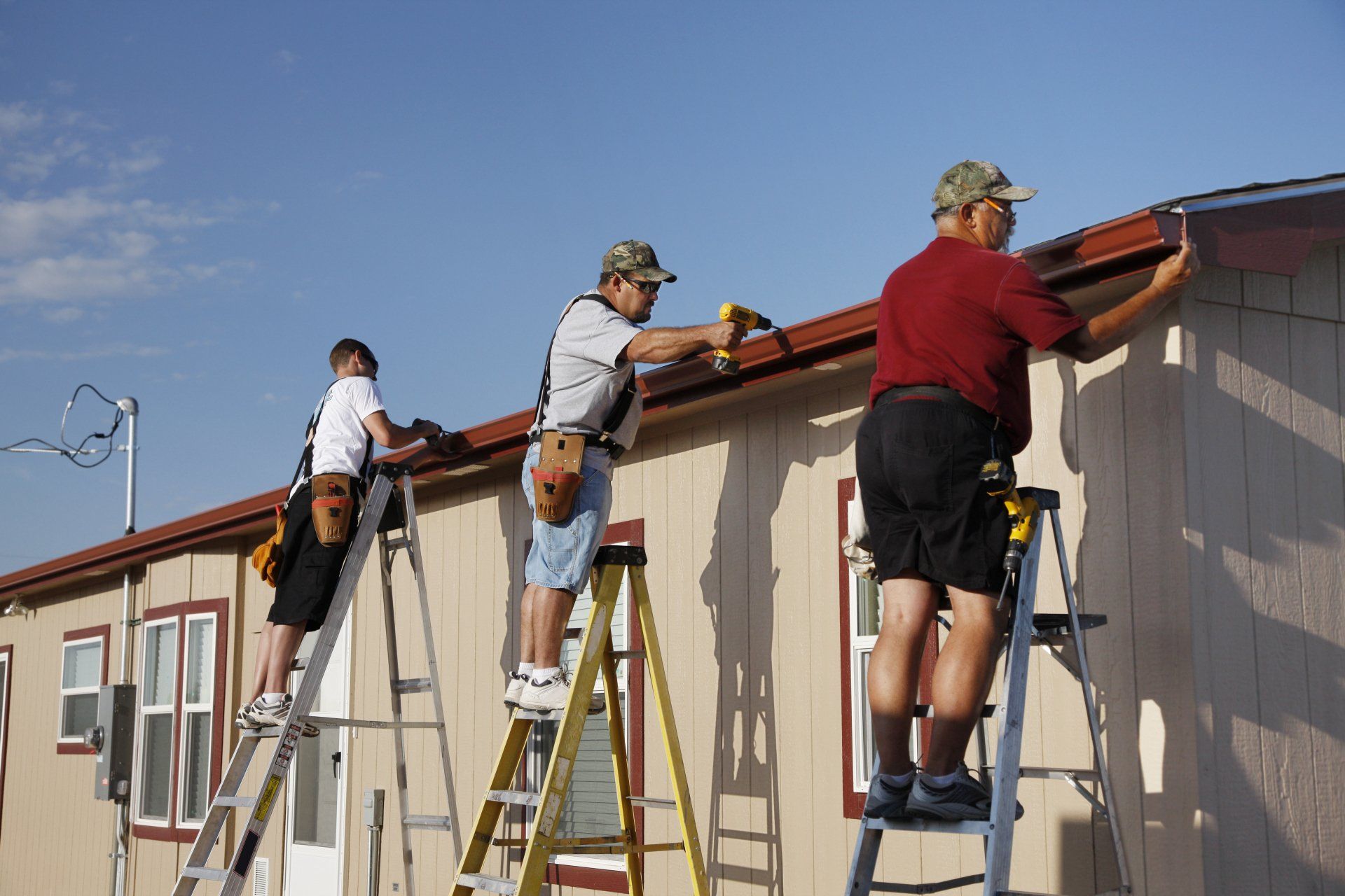 Artisans qui fixent une gouttière